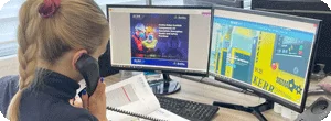 A Kerr service team colleague answering the phone in front of two computer screens